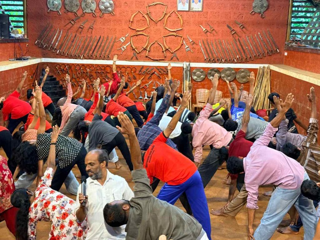 Participants practicing Kalaripayattu and Yoga wellness at the Kadathanadan Kalari Foundation event in Kammana.