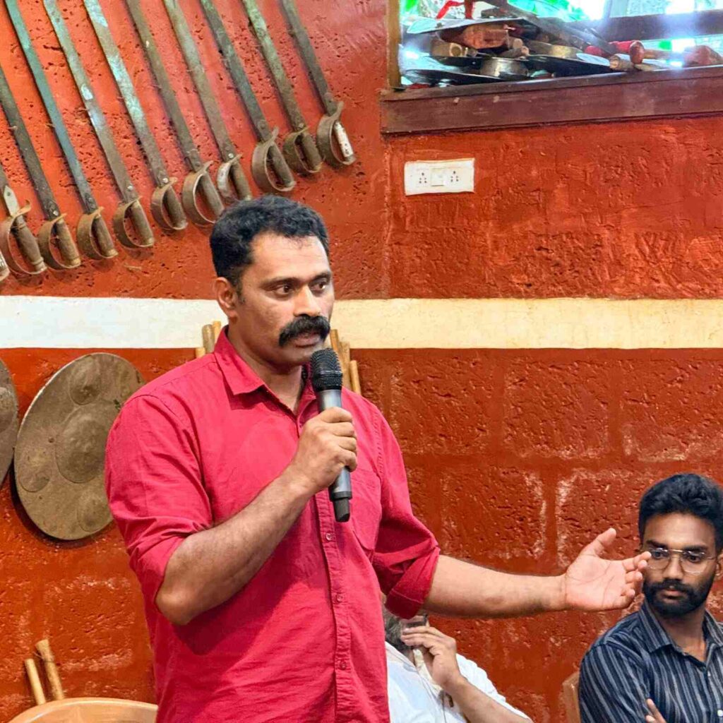 K.F. Thomas Gurukkal explaining the importance of Kalaripayattu and Yoga wellness at the Kammana event.