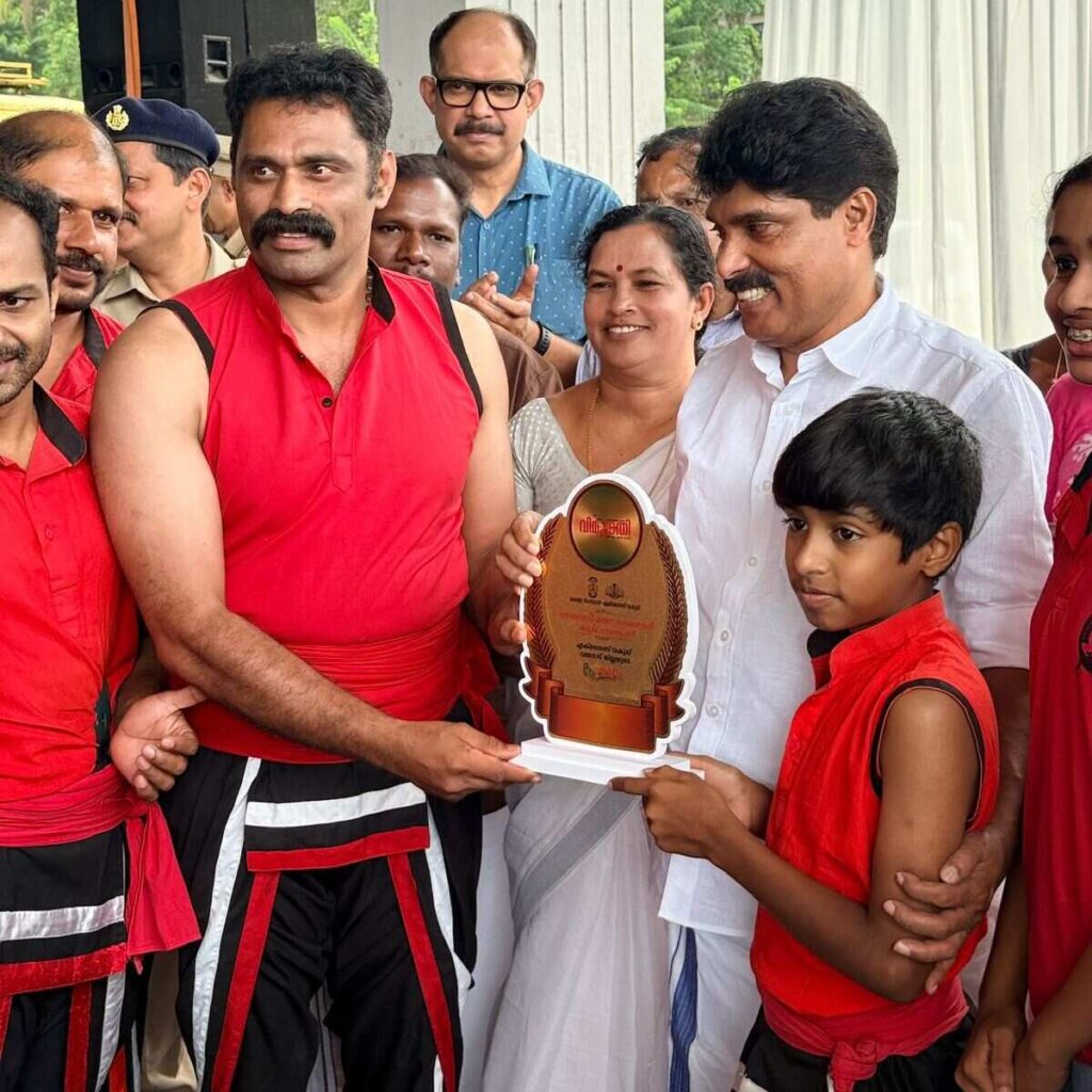 Kadathanadan Kalari Foundation Managing Director K.F. Thomas Gurukkal receiving an award from Kerala Agriculture Minister T. Siddique during the International Anti-Drug Day event organized by Wayanad Vimukthi Mission.